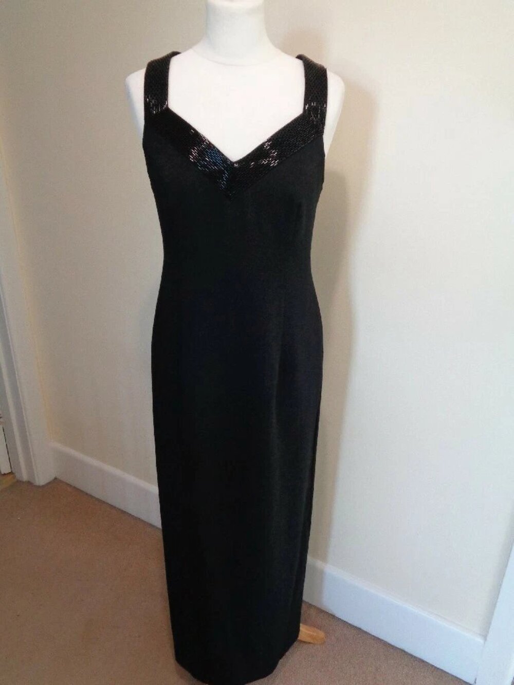 A black long evening dress, designed by J. Taylor